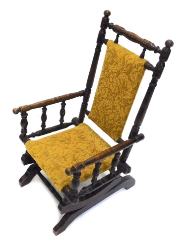 Appraisal: An early thC walnut child's American rocking chair overstuffed to