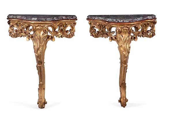 Appraisal: A pair of Italian Rococo style giltwood consoles A pair