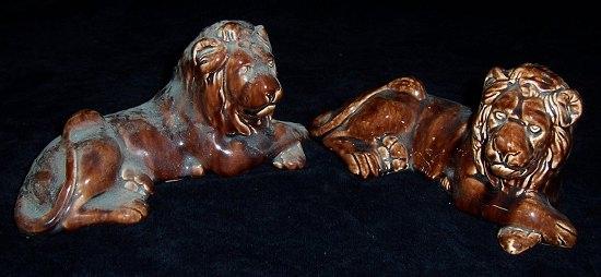 Appraisal: Two brown glazed recumbent lions one signed F Shaw