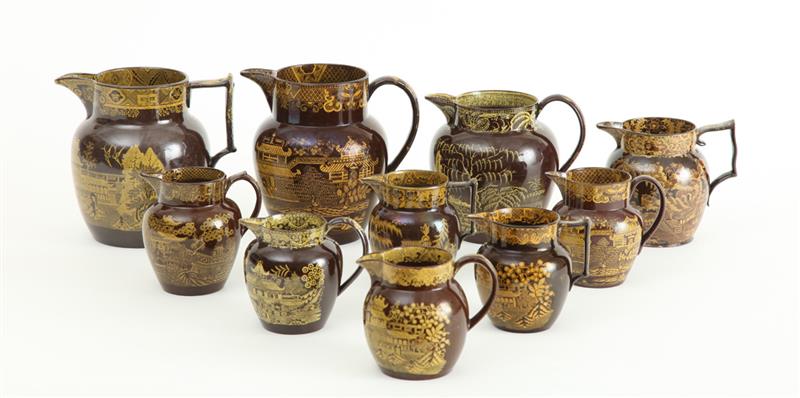 Appraisal: GROUP OF TEN STAFFORDSHIRE BROWN-GLAZED YELLOW TRANSFERWARE DECORATED PITCHERS AND