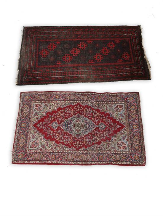 Appraisal: TWO ORIENTAL RUGS Bokhara and Persian floral style designs Wear