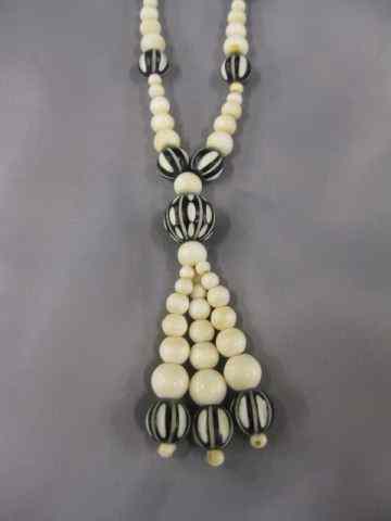 Appraisal: Carved Ivory Bead Necklace tassel style end some ivory beads