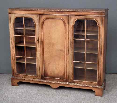 Appraisal: A s figured walnut bookcase fitted nine shelves enclosed by