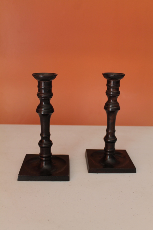 Appraisal: A pair of modern bronze patinated candlesticks cm high