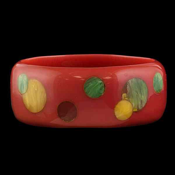 Appraisal: Vintage ''Mod'' Bakelite Bangle An orange bakelite bangle inlayed with