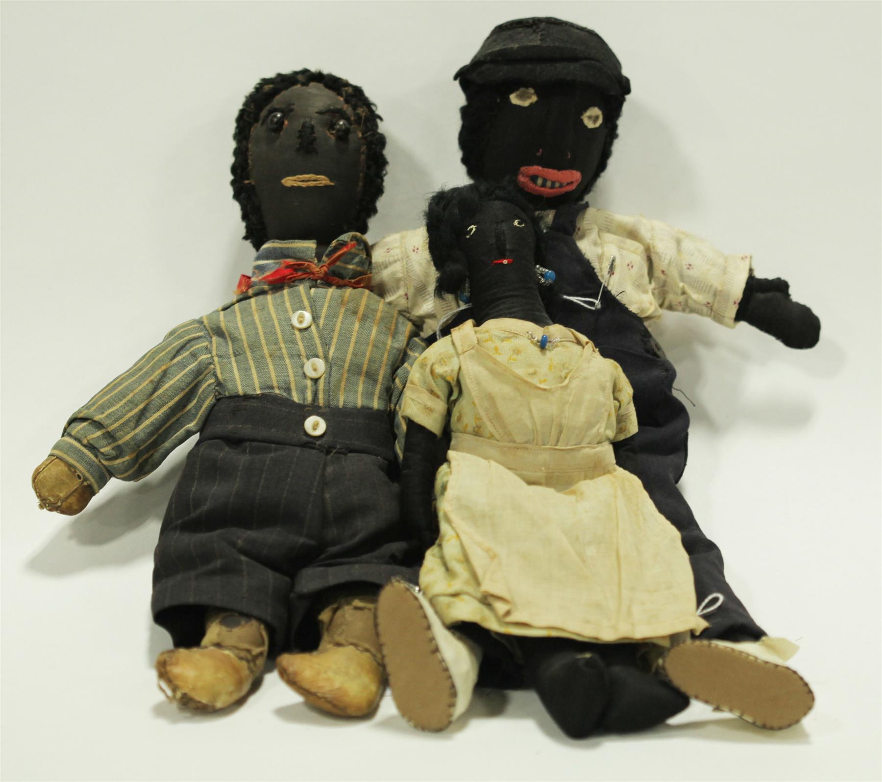 Appraisal: THREE EARLY BLACK CLOTH DOLLS WITH WOOL HAIR American late