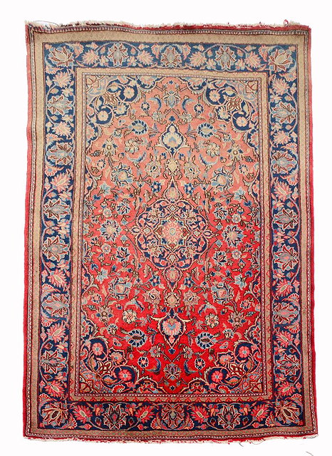 Appraisal: A PERSIAN KASHAN RED GROUND RUG with a central design