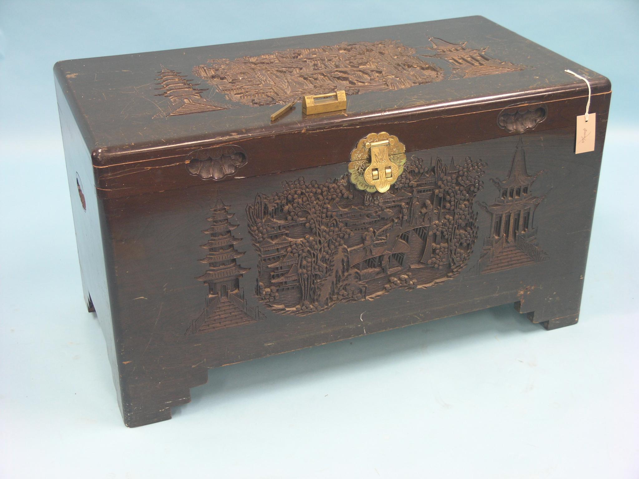 Appraisal: An eastern camphorwood blanket chest with deeply-carved ornament engraved brass