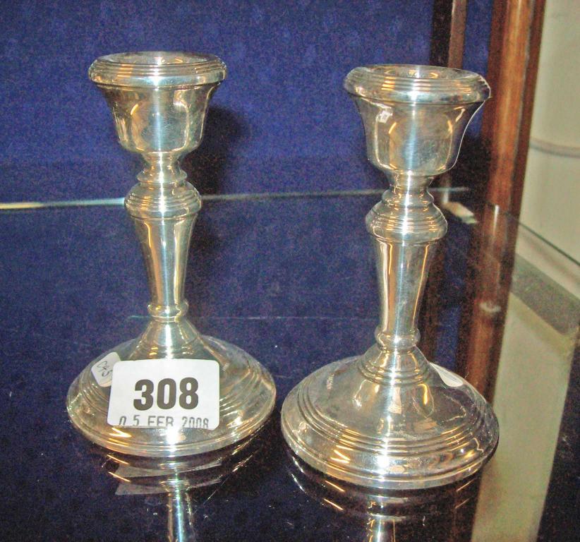 Appraisal: A pair of silver table candlesticks -