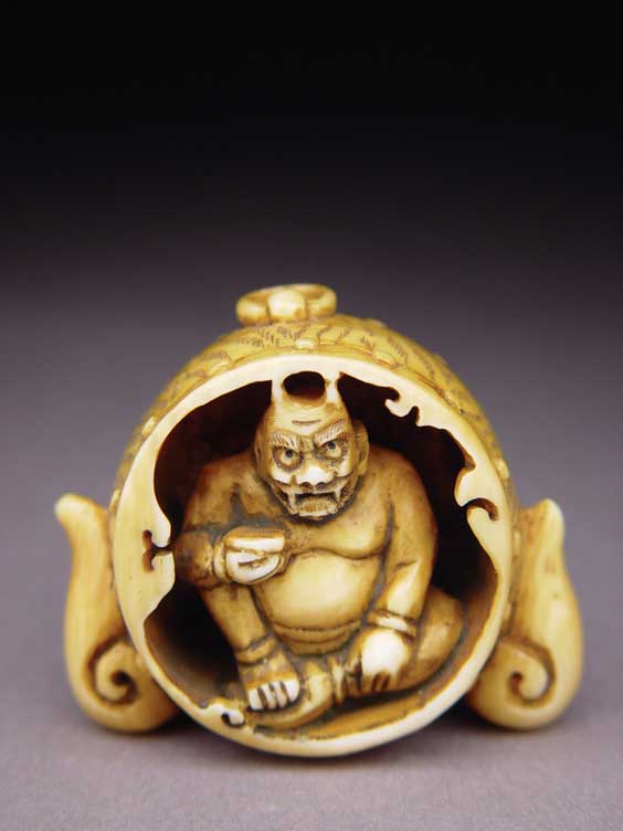 Appraisal: CARVED IVORY NETSUKE Contemporary stained and well carved ivory netsuke