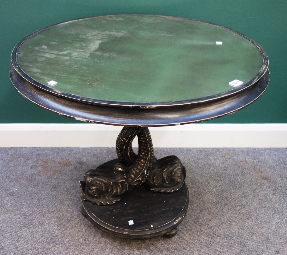 Appraisal: A George II style mirror top ebonised round table on