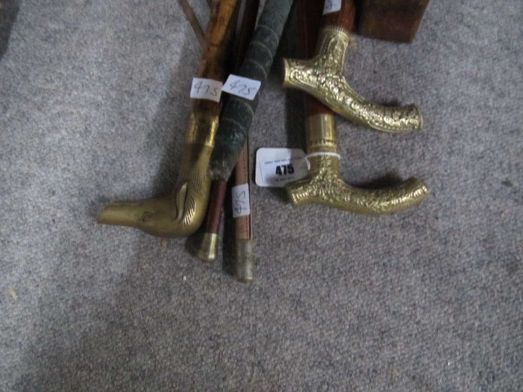 Appraisal: Lot comprising three walking sticks a swagger stick a riding