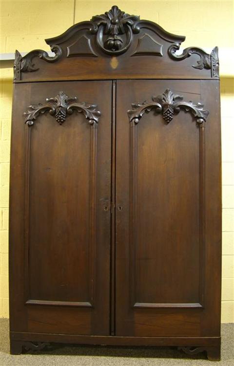 Appraisal: VICTORIAN CARVED ARMOIRE poss Southern the scrolling cornice with central