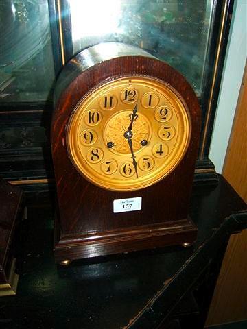 Appraisal: An oak mantel clock with gilt Arabic dial and French