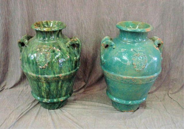 Appraisal: Pair of Double Handled Green Pottery Urns From the entrance