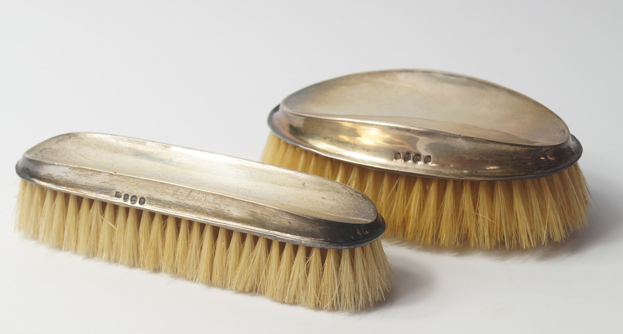 Appraisal: A George V silver backed hair and clothes brush set