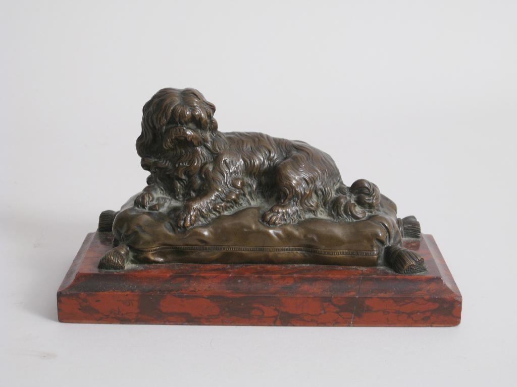 Appraisal: A bronze Model of a long haired dog sat on