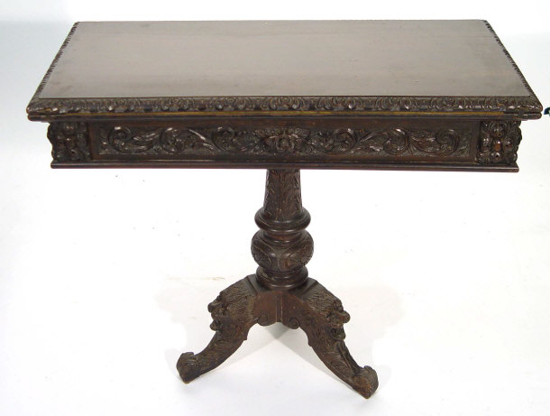 Appraisal: Oak foldover card table with swivel top heavily carved with