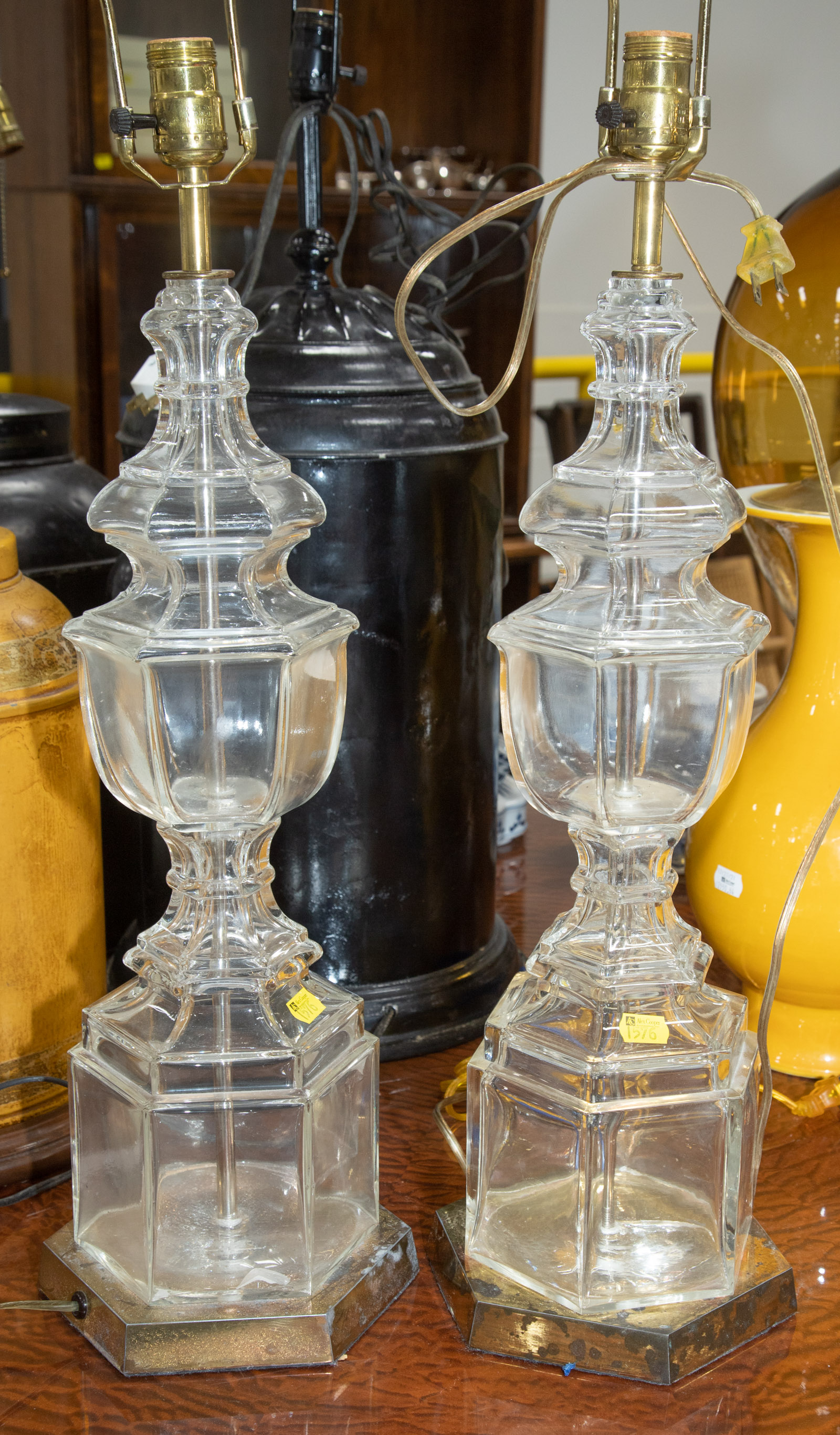 Appraisal: A PAIR OF COLORLESS GLASS TABLE LAMPS Mounted on brass