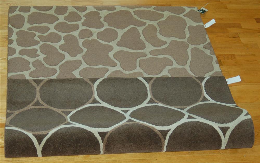 Appraisal: WHITAKER REVERSIBLE WOOL RUG one side having a tan and