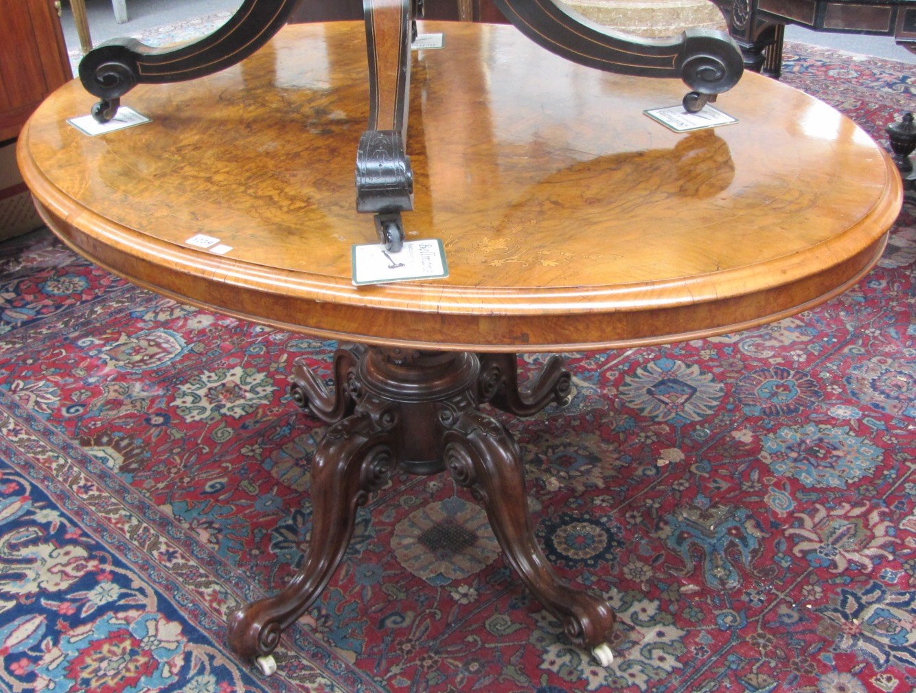 Appraisal: A Victorian inlaid figured walnut oval loo table on four