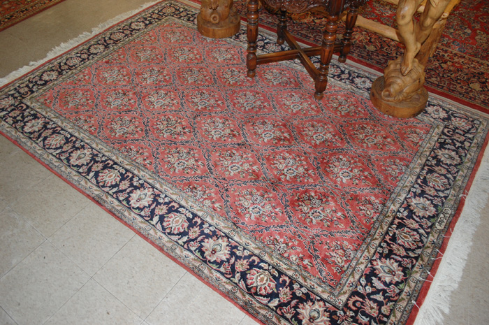 Appraisal: SIGNED HAND KNOTTED ORIENTAL CARPET Pakistani Tabriz repeating floral diamond-shaped