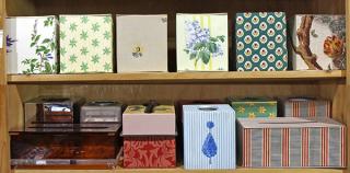 Appraisal: Two shelves of decorative tissue box covers executed in metal