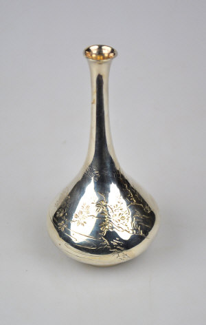 Appraisal: A Japanese white metal onion-shaped bottle-vase with engraved decoration seal