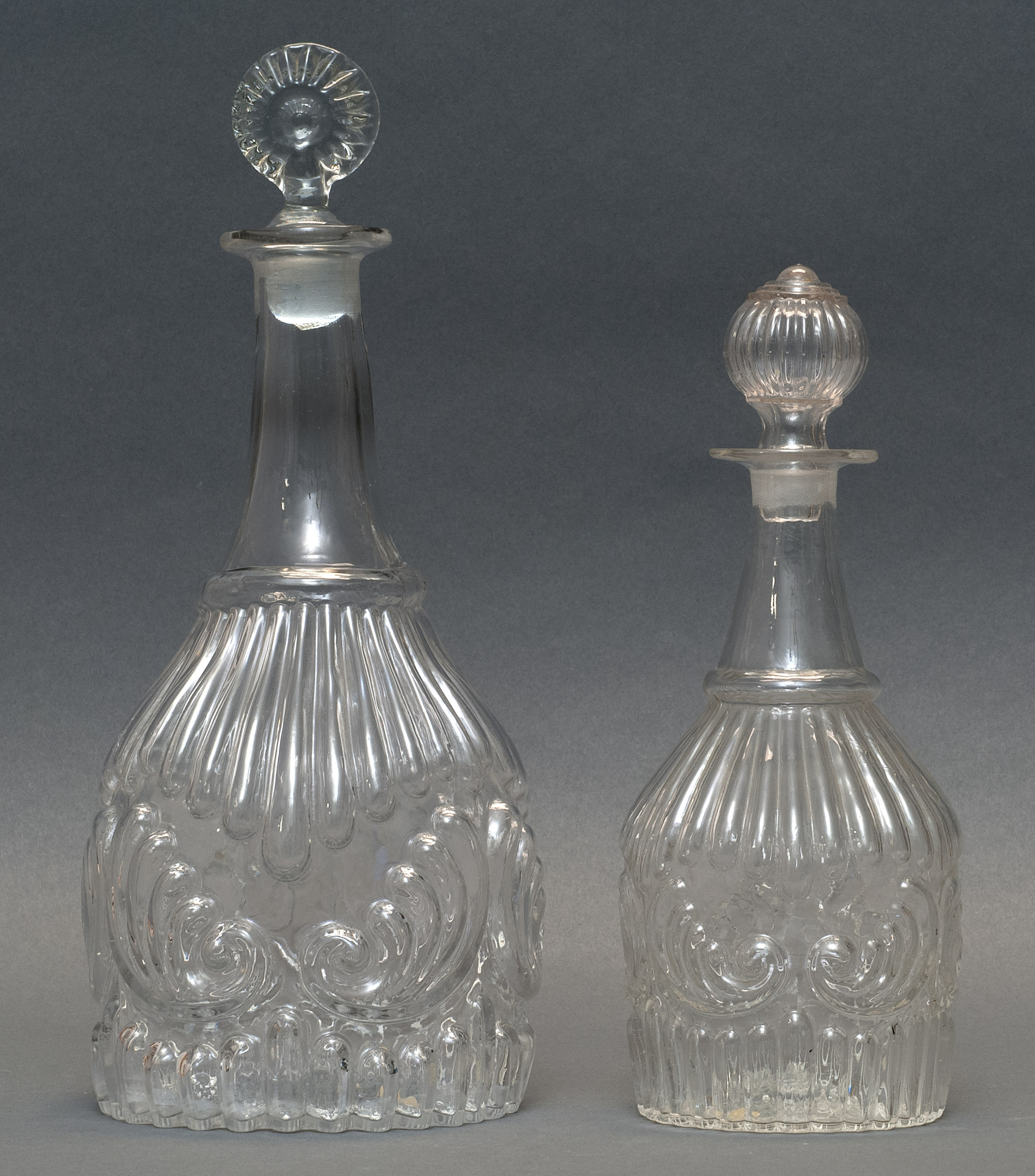 Appraisal: TWO CLEAR GLASS BLOWN -MOLD DECANTERS Second Quarter of the