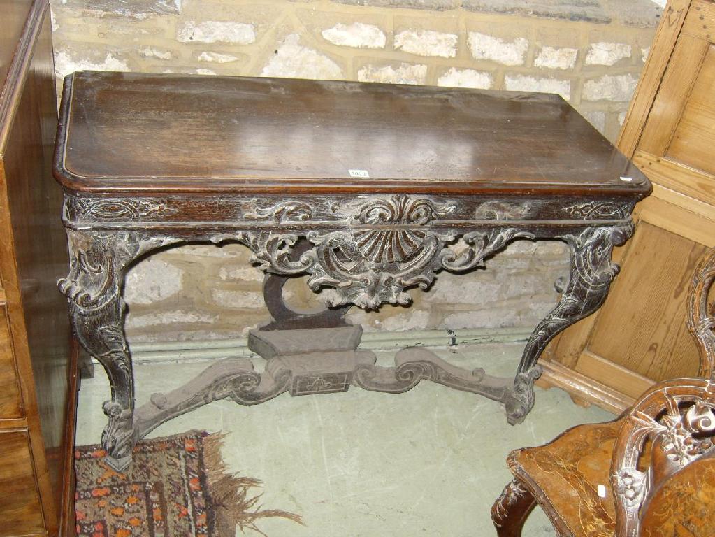 Appraisal: A Victorian oak pier table with profusely carved swag and