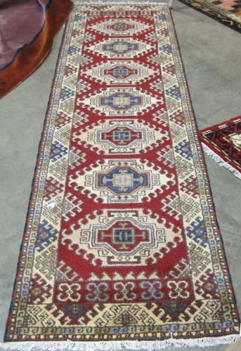 Appraisal: HAND KNOTTED ORIENTAL RUNNER Indo-Kazak tribal featuring seven latch-hook medallions