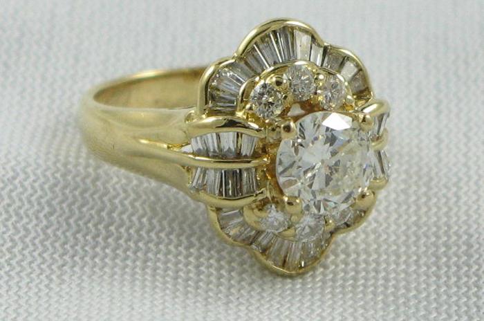 Appraisal: DIAMOND AND EIGHTEEN KARAT GOLD RING centering a round brilliant-cut