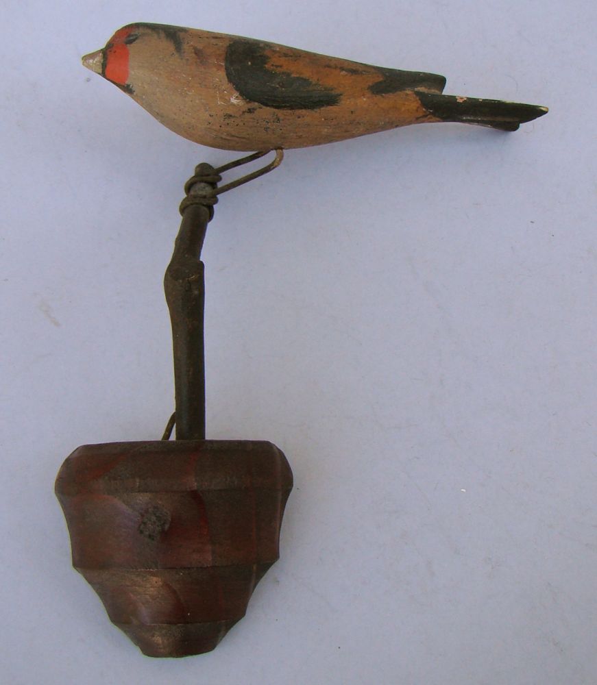 Appraisal: FOLK ART CARVED AND PAINTED WOODEN GOLDFINCH Mounted on a