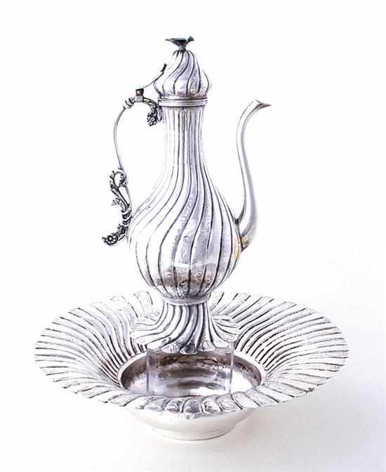 Appraisal: Persian decorated silverplate ewer and centerbowl set bird finial atop