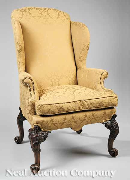 Appraisal: An Antique George III Carved Mahogany Wing Chair upholstered in