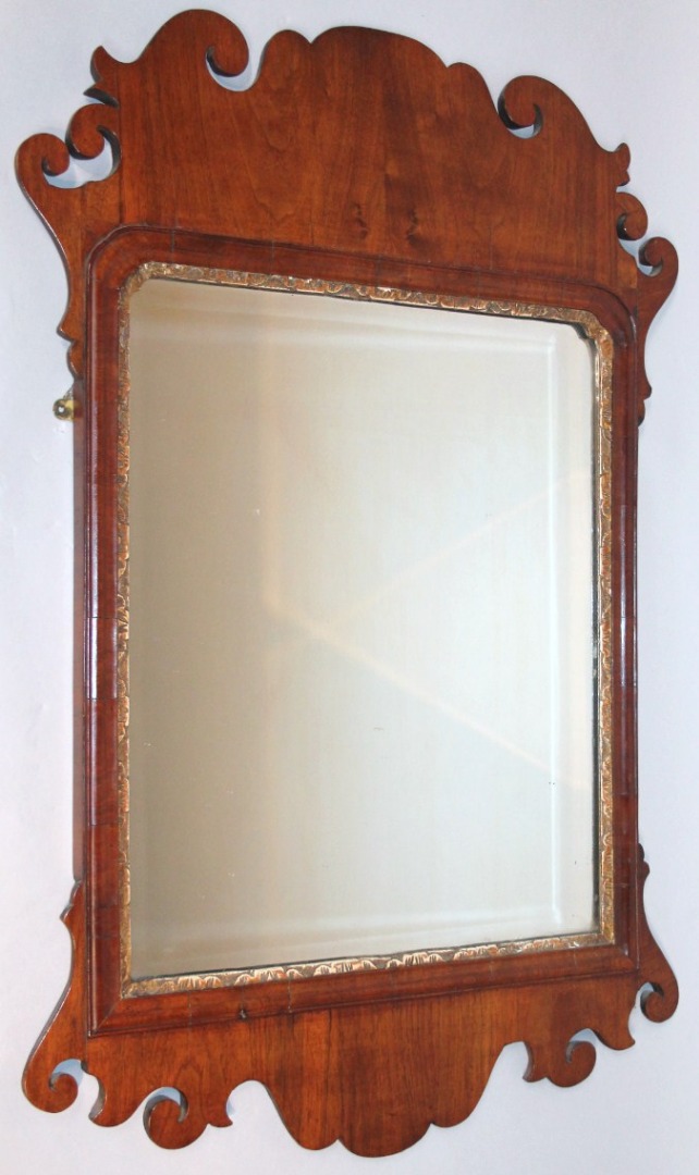 Appraisal: A thC walnut framed pier glass the shaped scroll frame