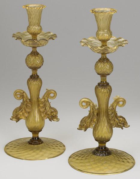 Appraisal: MURANO GLASS CANDLESTICKS Pair in amber glass with applied dolphin