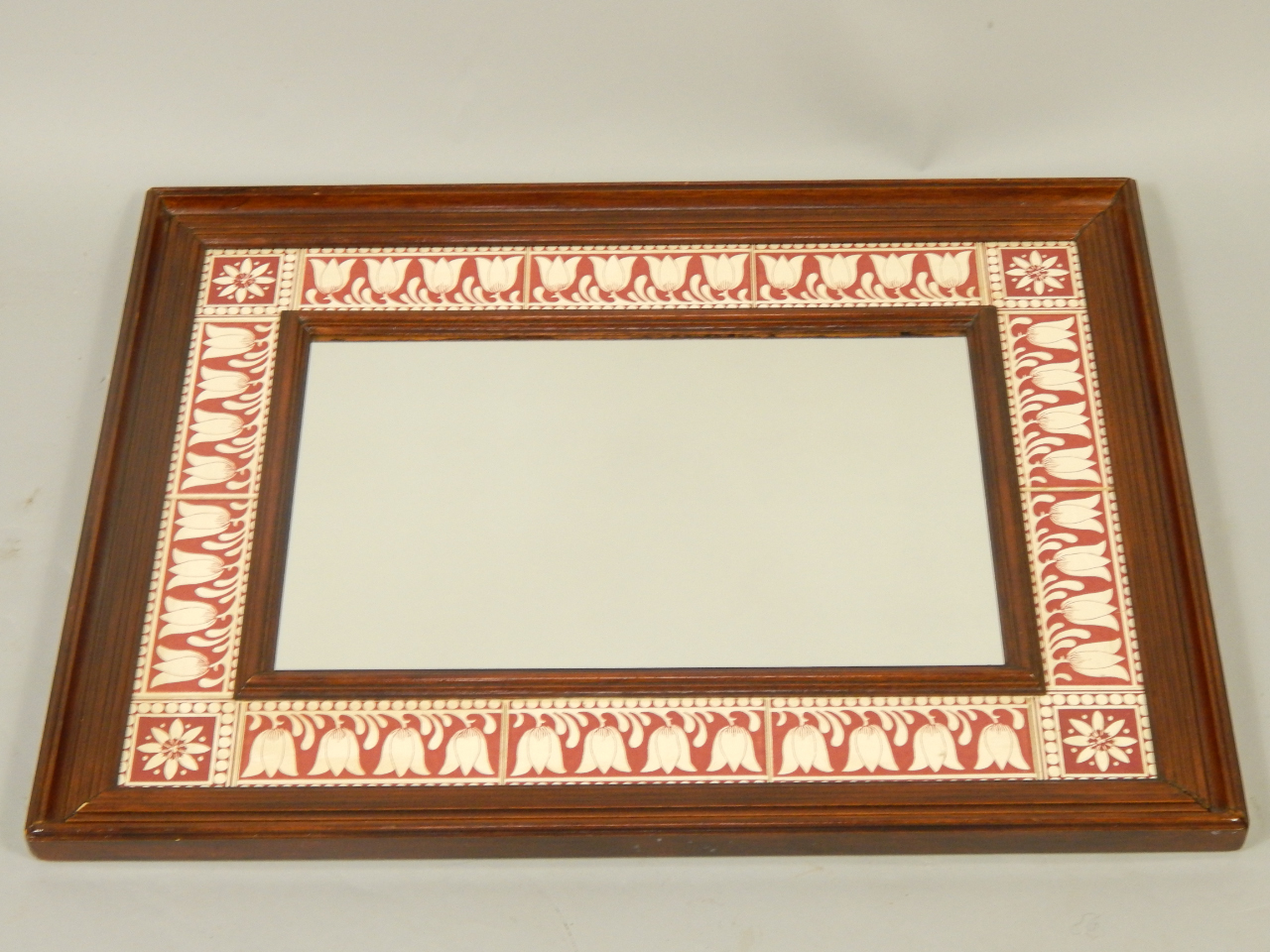 Appraisal: A beech and tile inset rectangular wall mirror the tiles