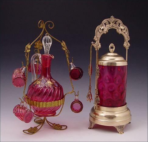 Appraisal: CRANBERRY GLASS PICKLE CASTOR AND DECANTER SET Cranberry Coinspot glass