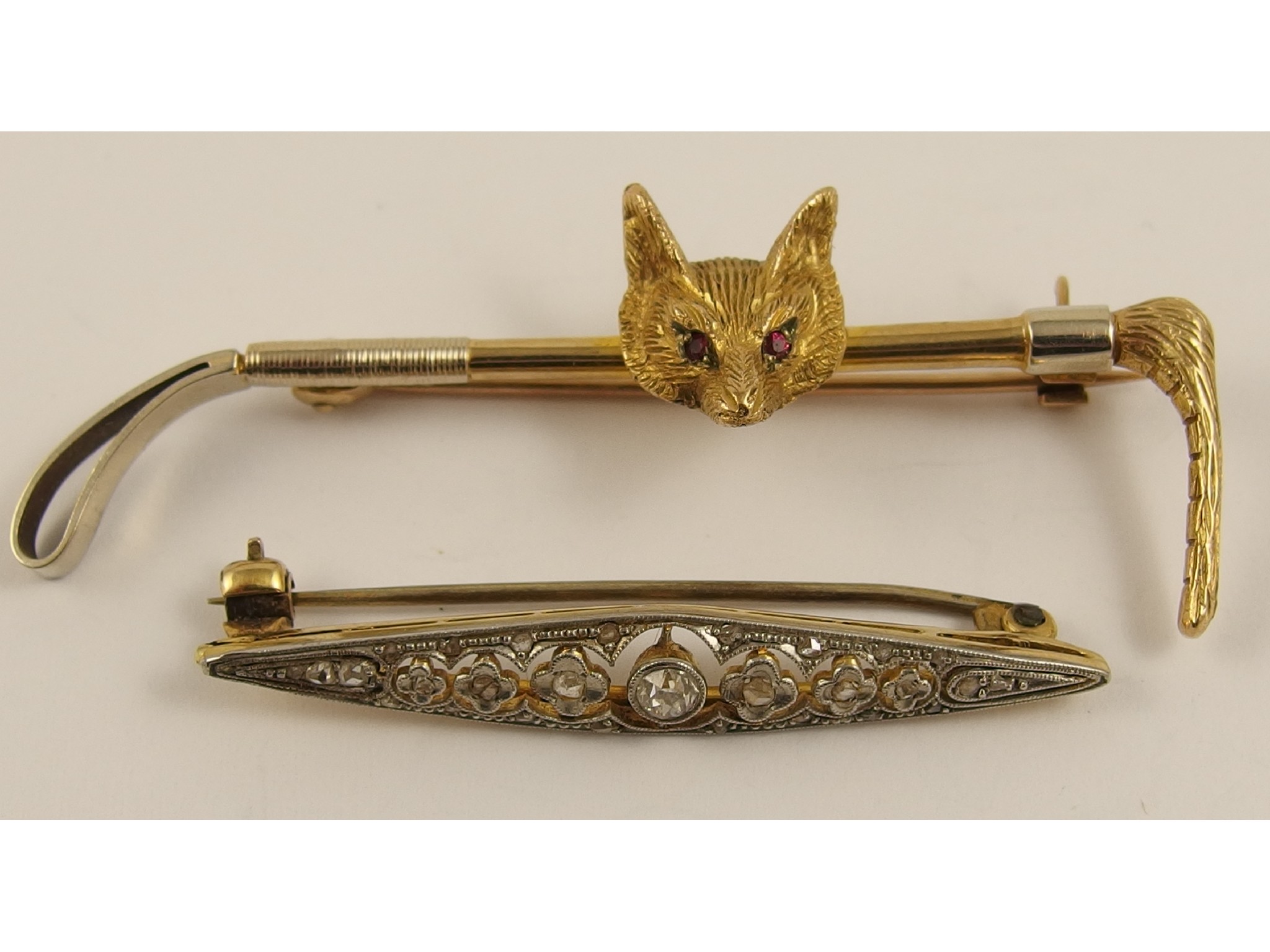 Appraisal: A ct fox and riding crop brooch and a yellow