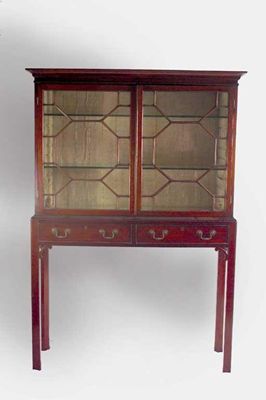 Appraisal: A mahogany cabinet on stand the cavetto moulded cornice above