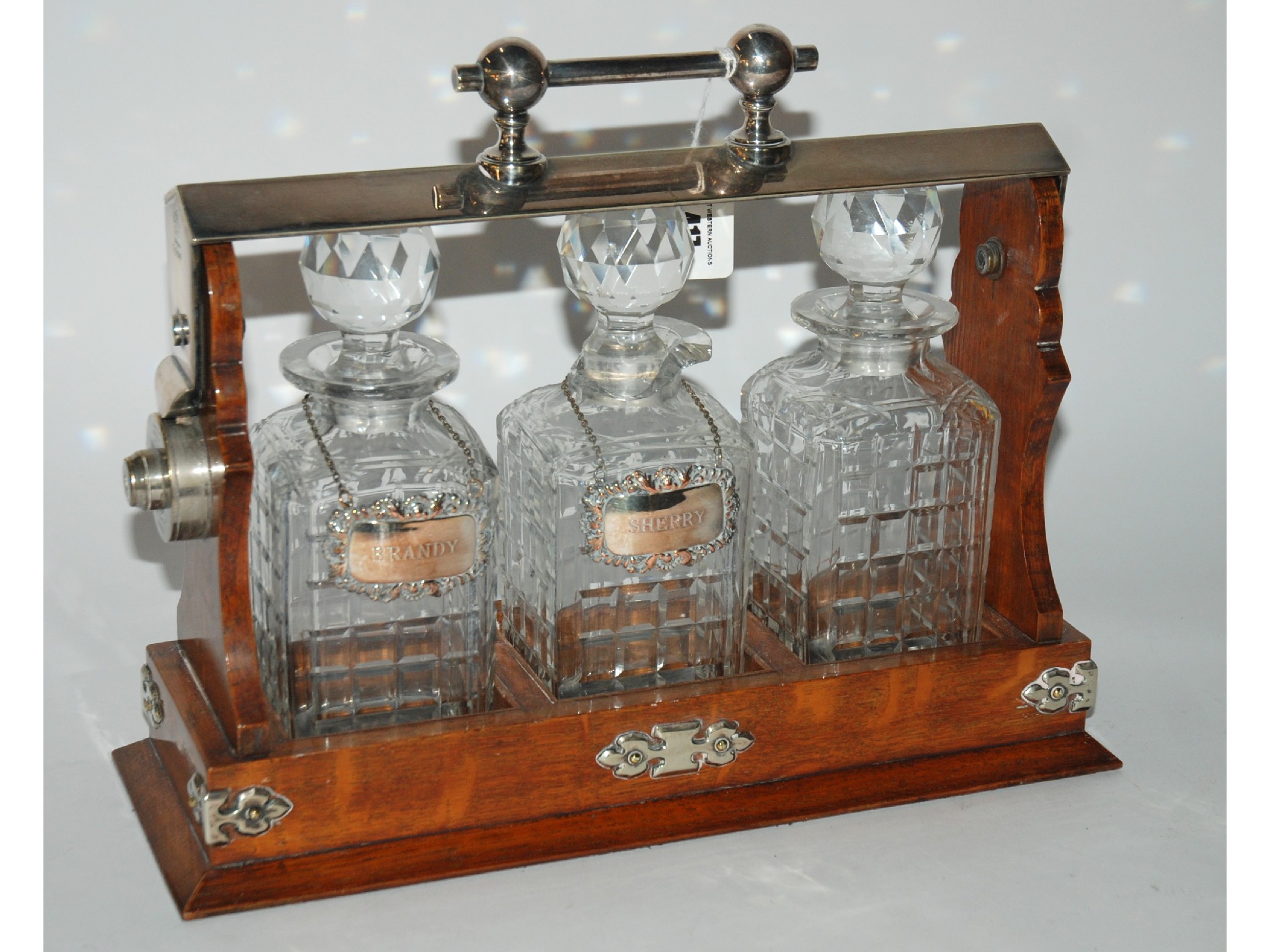 Appraisal: A late th early th century three bottle Tantalus in