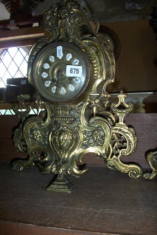 Appraisal: A rococo style brass mantle clock the flamboyant case with