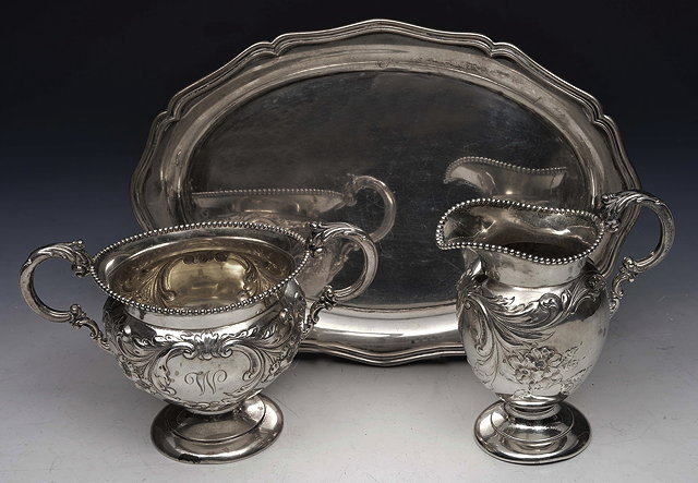 Appraisal: A WHITE METAL TWIN HANDLED SUGAR BASIN and matching milk