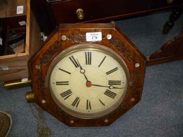 Appraisal: A CONTINENTAL STAINED PINE OCTAGONAL POSTMAN'S ALARM WALL CLOCK the