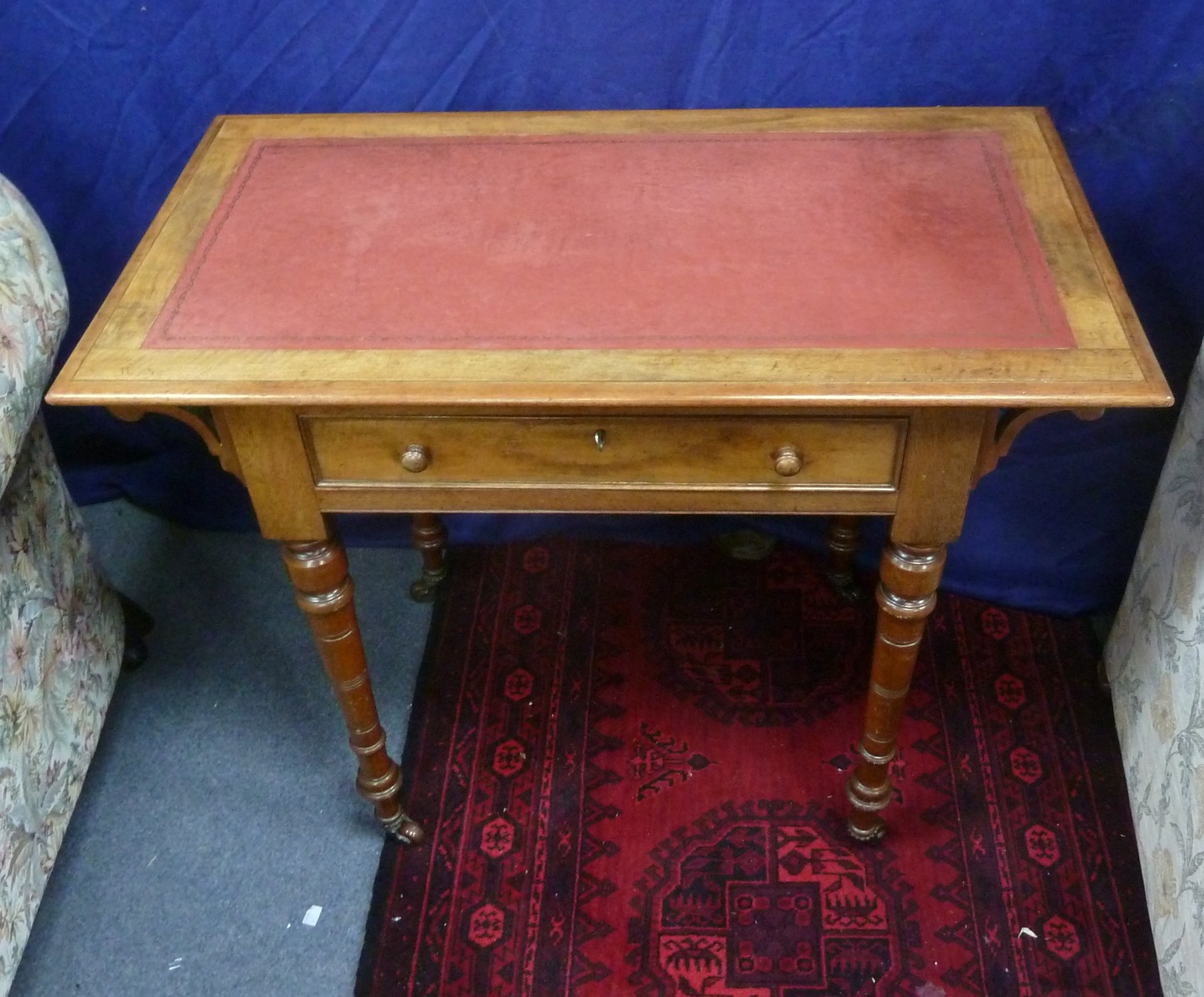 Appraisal: A walnut writing table with leather lined top fitted a