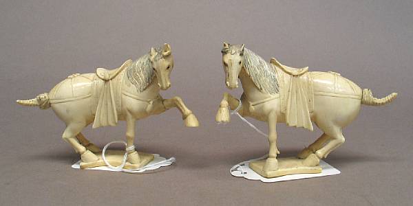 Appraisal: A pair of carved ivory horses The pair shown as