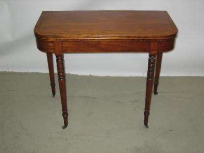 Appraisal: A MAHOGANY FOLDING TEA TABLE of rounded oblong form with