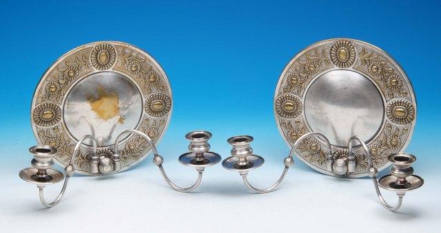 Appraisal: A pair of Victorian aesthetic silver plated wall sconces of