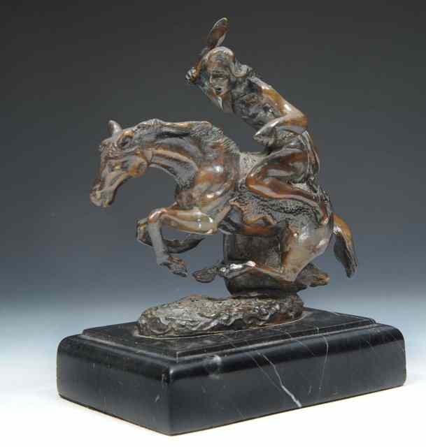 Appraisal: A CAST BRONZE FIGURE of a warrior on bucking horse